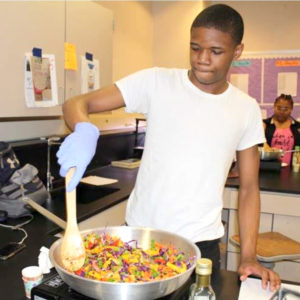 Teenager learning to cook