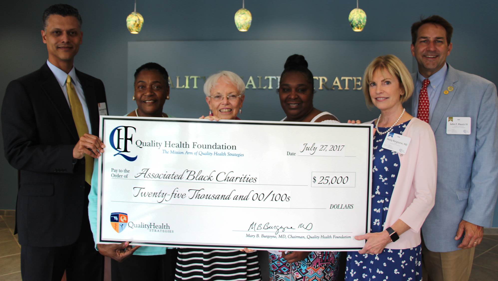 Associated Black Charities, Inc. group photo with QHF check