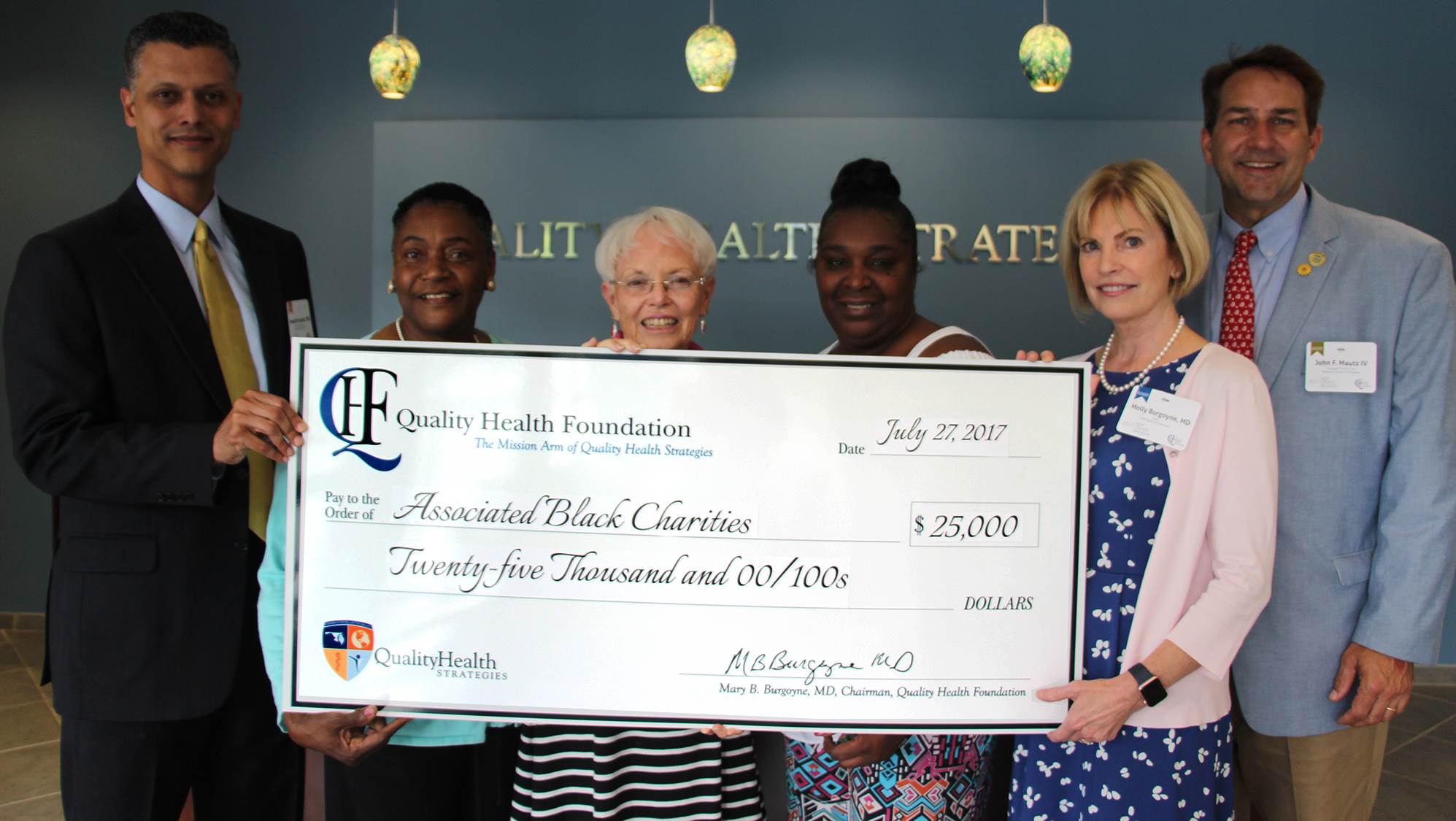 Associated Black Charities, Inc. group photo with QHF check