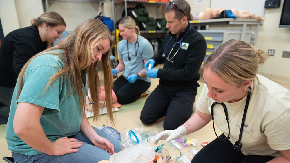 Chesapeake College Students practicing on a medical manikin
