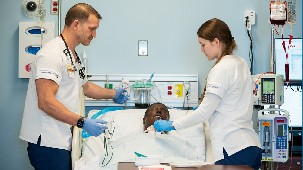 Chesapeake College Students practicing on a medical manikin