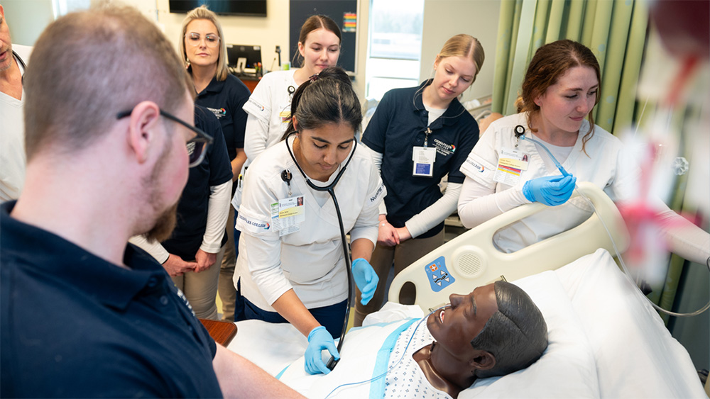 Chesapeake College Students practicing on a medical manikin