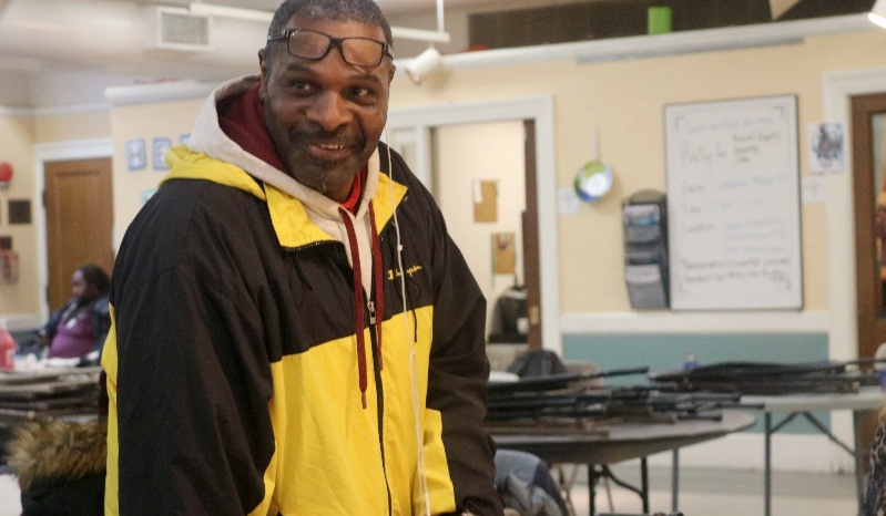 A man smiling at the Miriam's Kitchen location