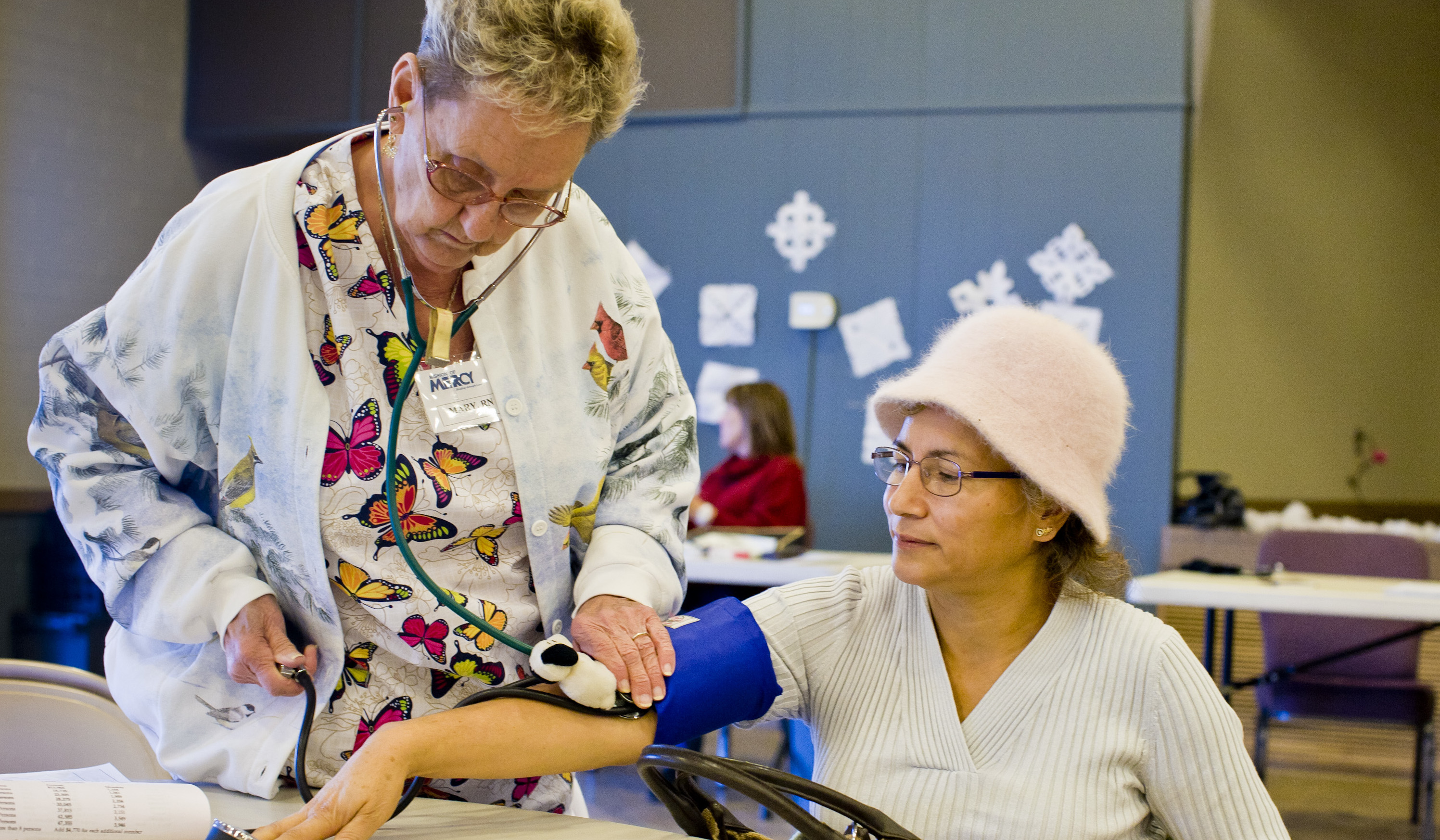 A medical professional takes a clients blood pressure