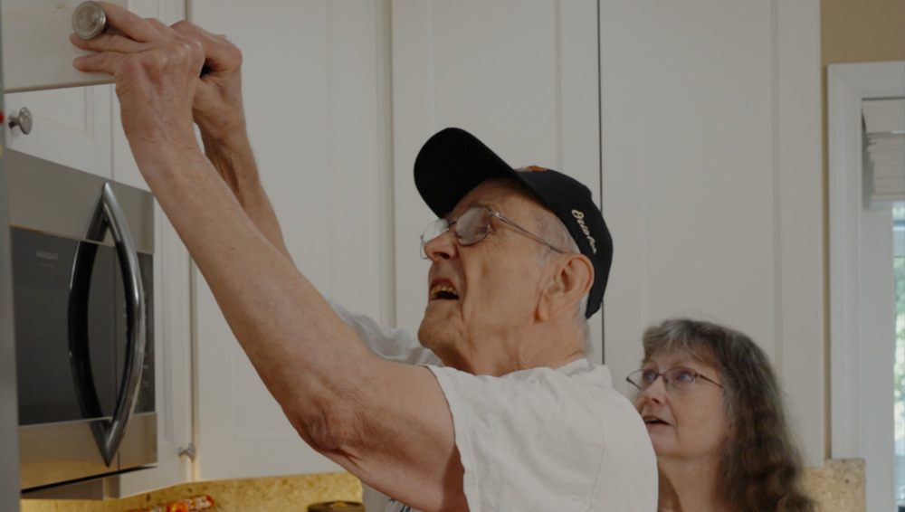 A man repairing a cabinet