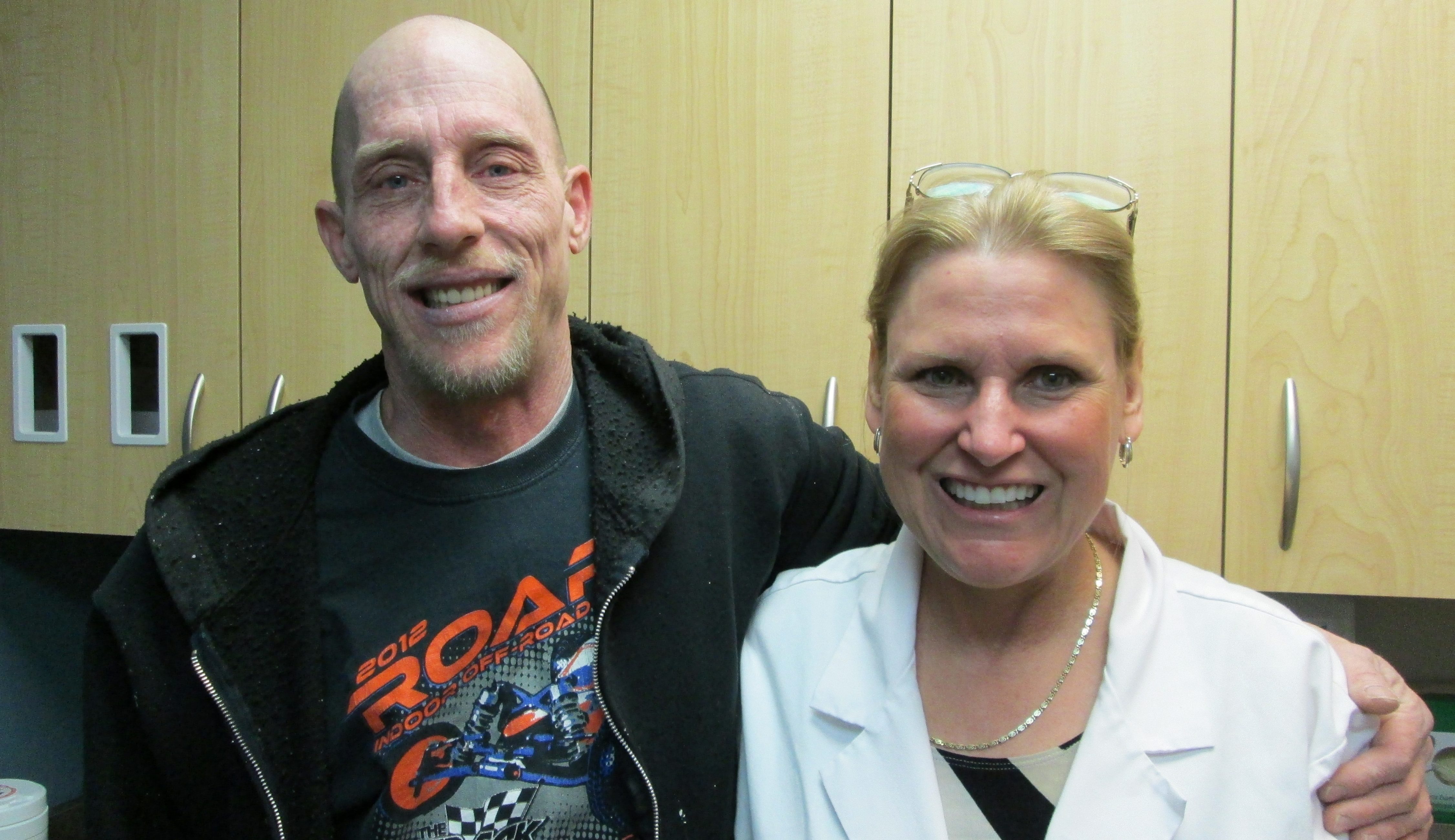 Patient with arm around the shoulders of his dentist