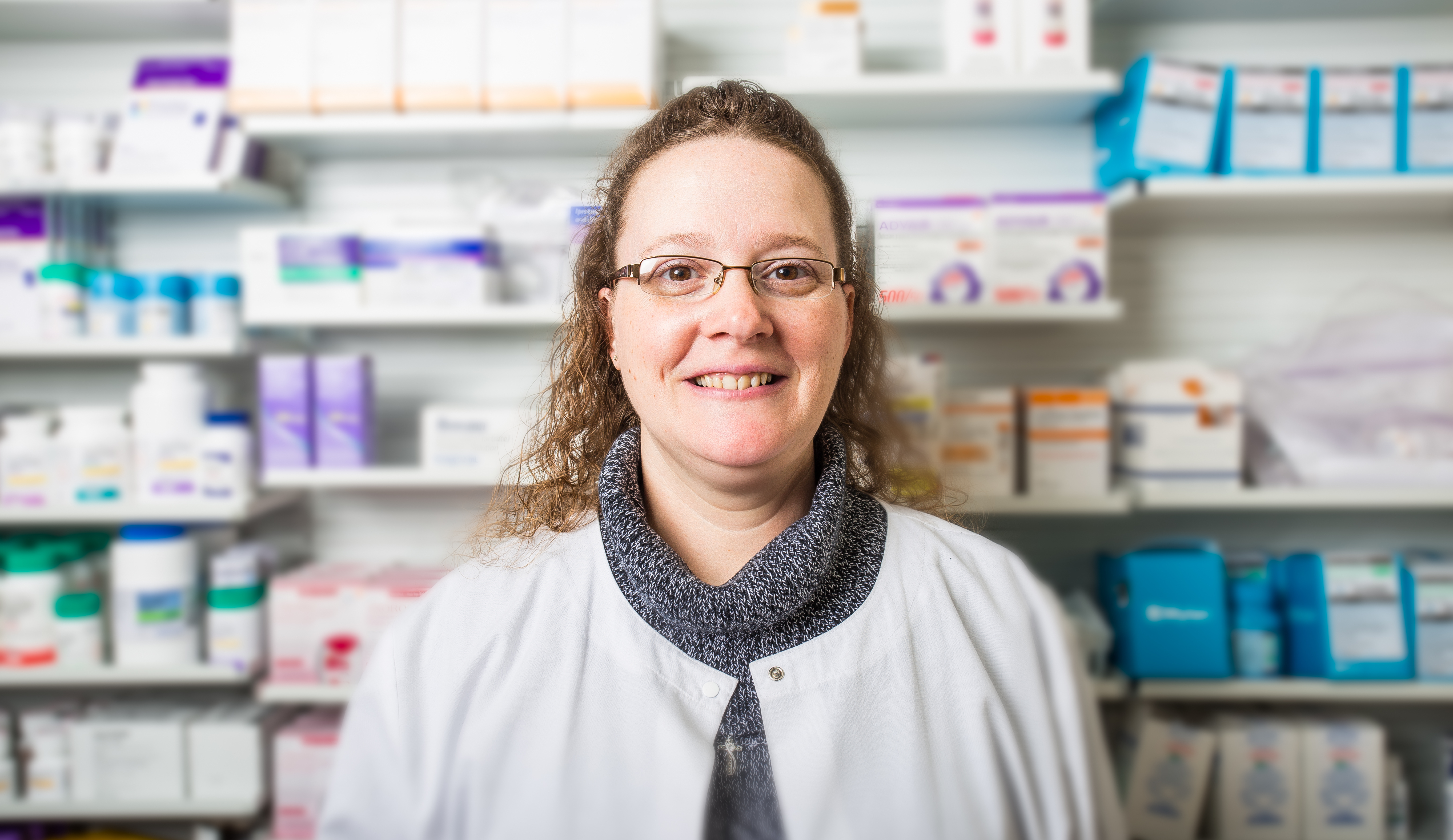 Pharmacist in a Pharmacy looking into the camera