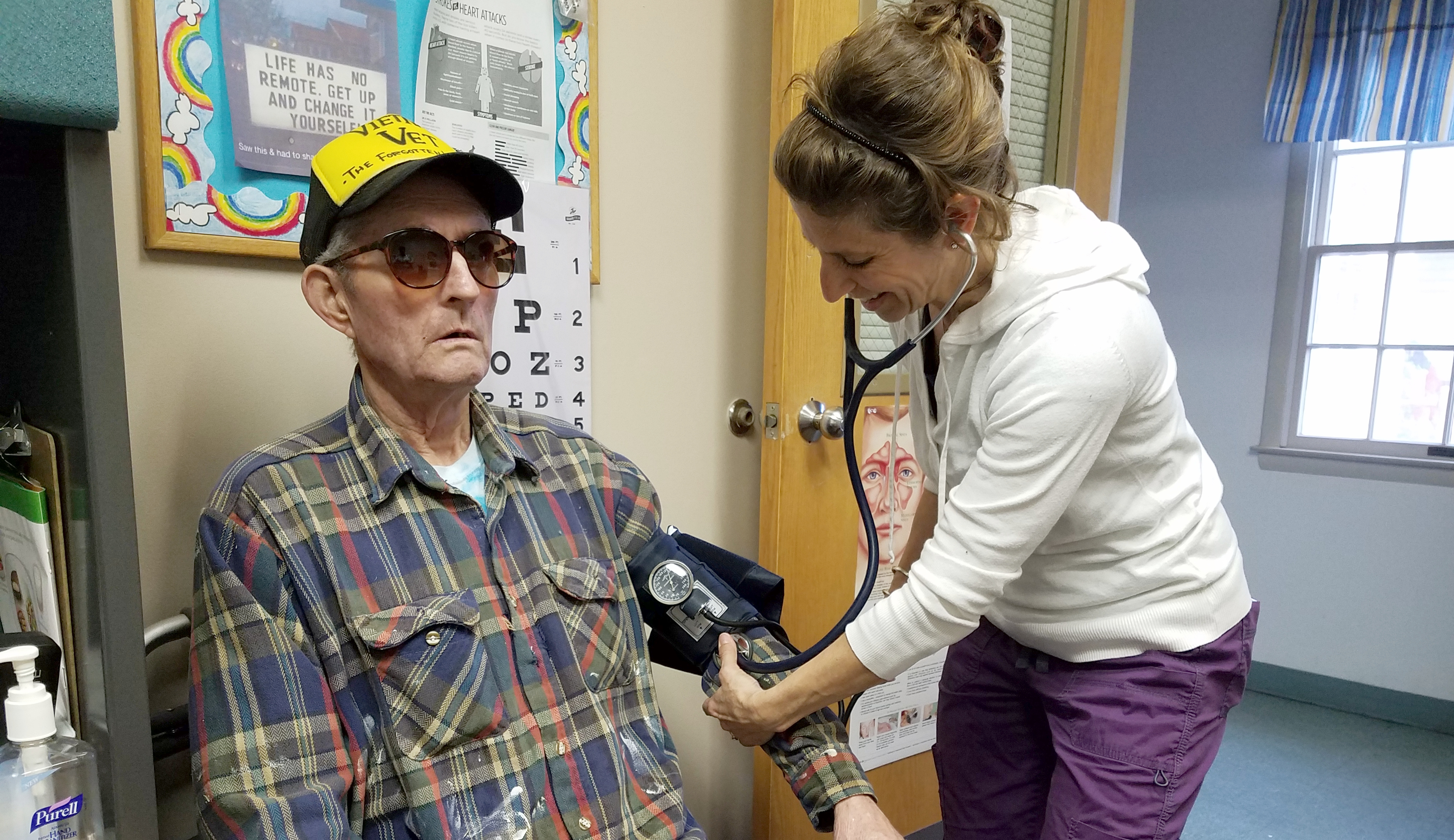 Healthcare provider taking patient's blood pressure