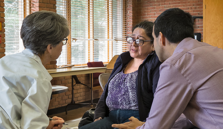 Two Medical professionals speaking with a patient