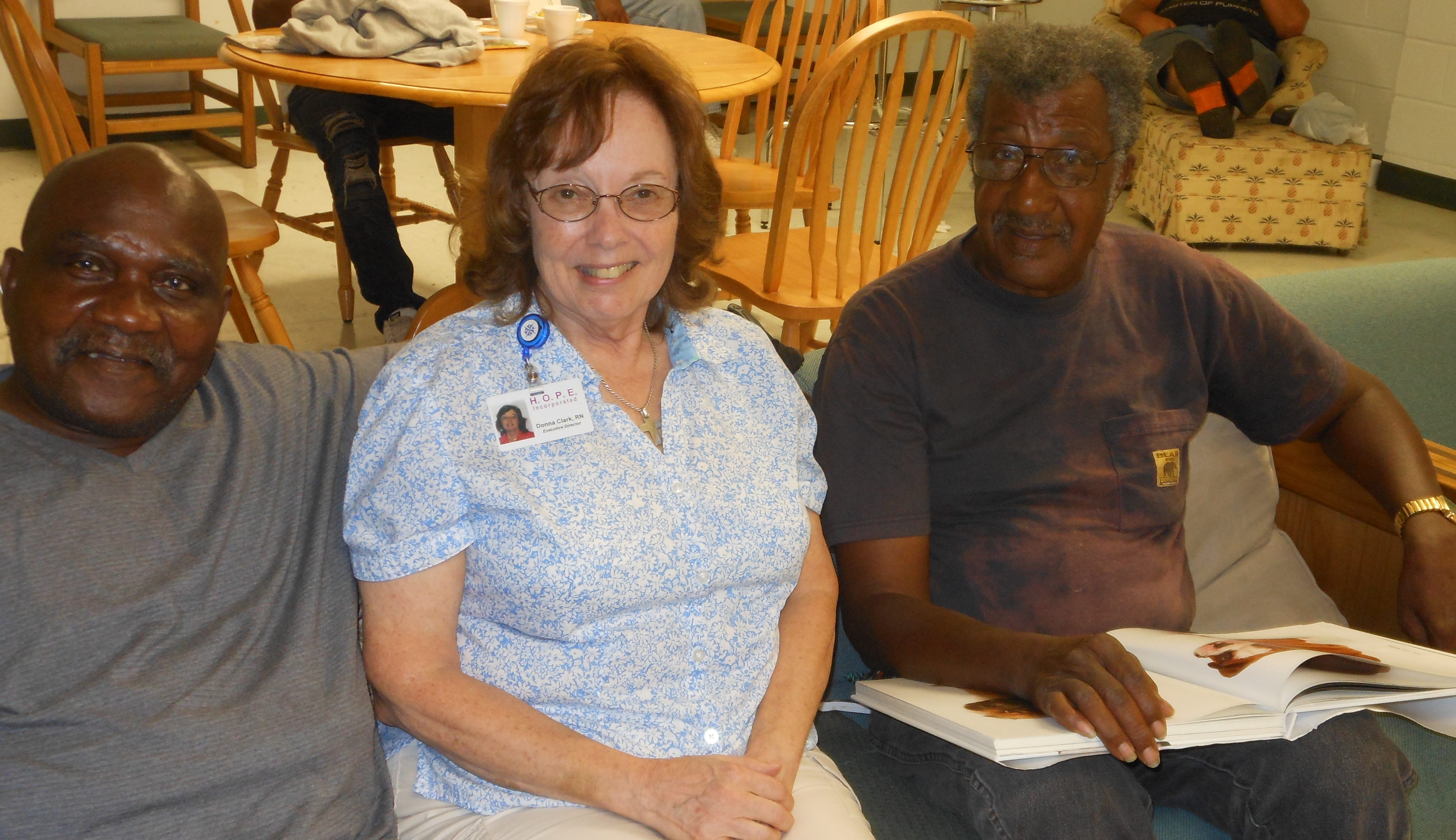 A man and woman on a couch facing the camera