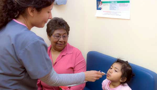 Medical provider taking a child's temperature