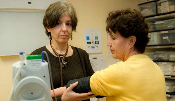 Medical provider taking a woman's blood pressure