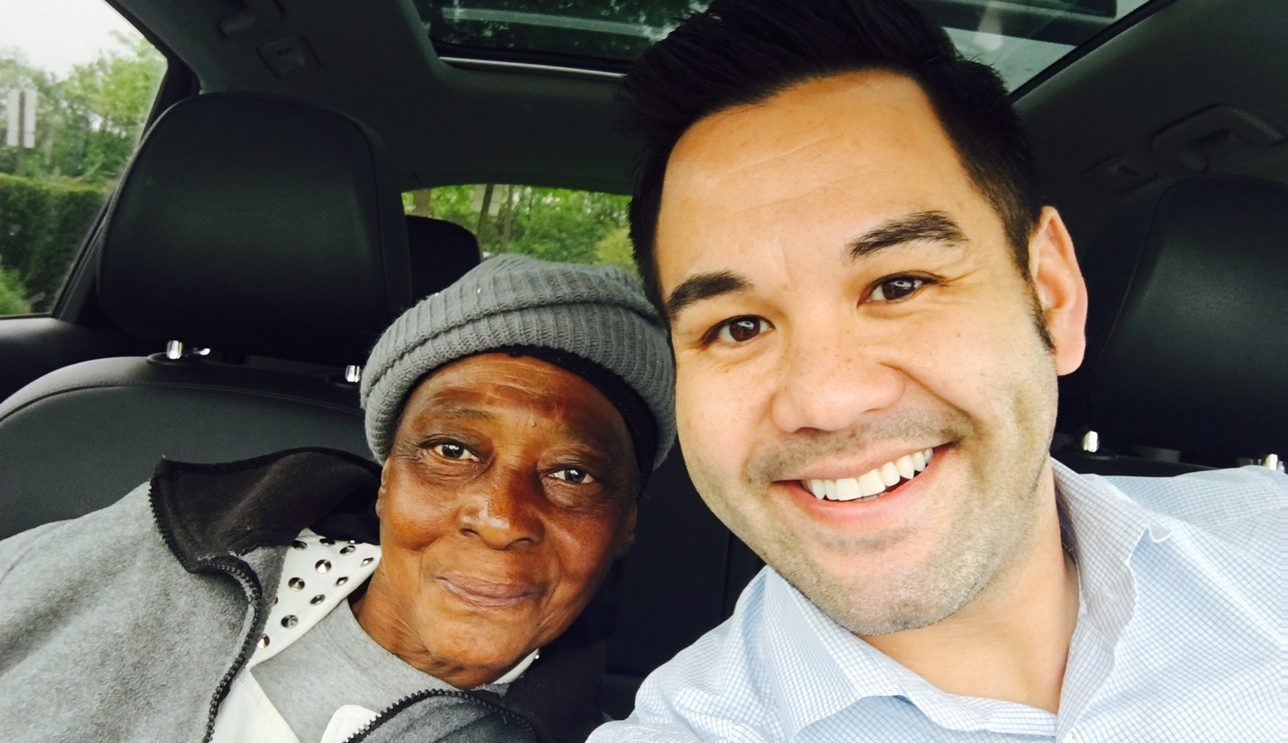 A man and woman taking a selfie in a car