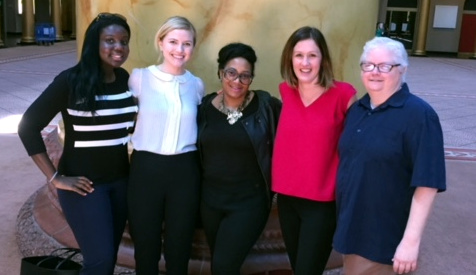 Group of women with arms around each other posing for the camera