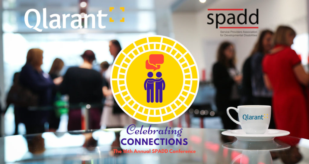 blurry coffee break room with Qlarant, SPADD, and Conference logos superimposed