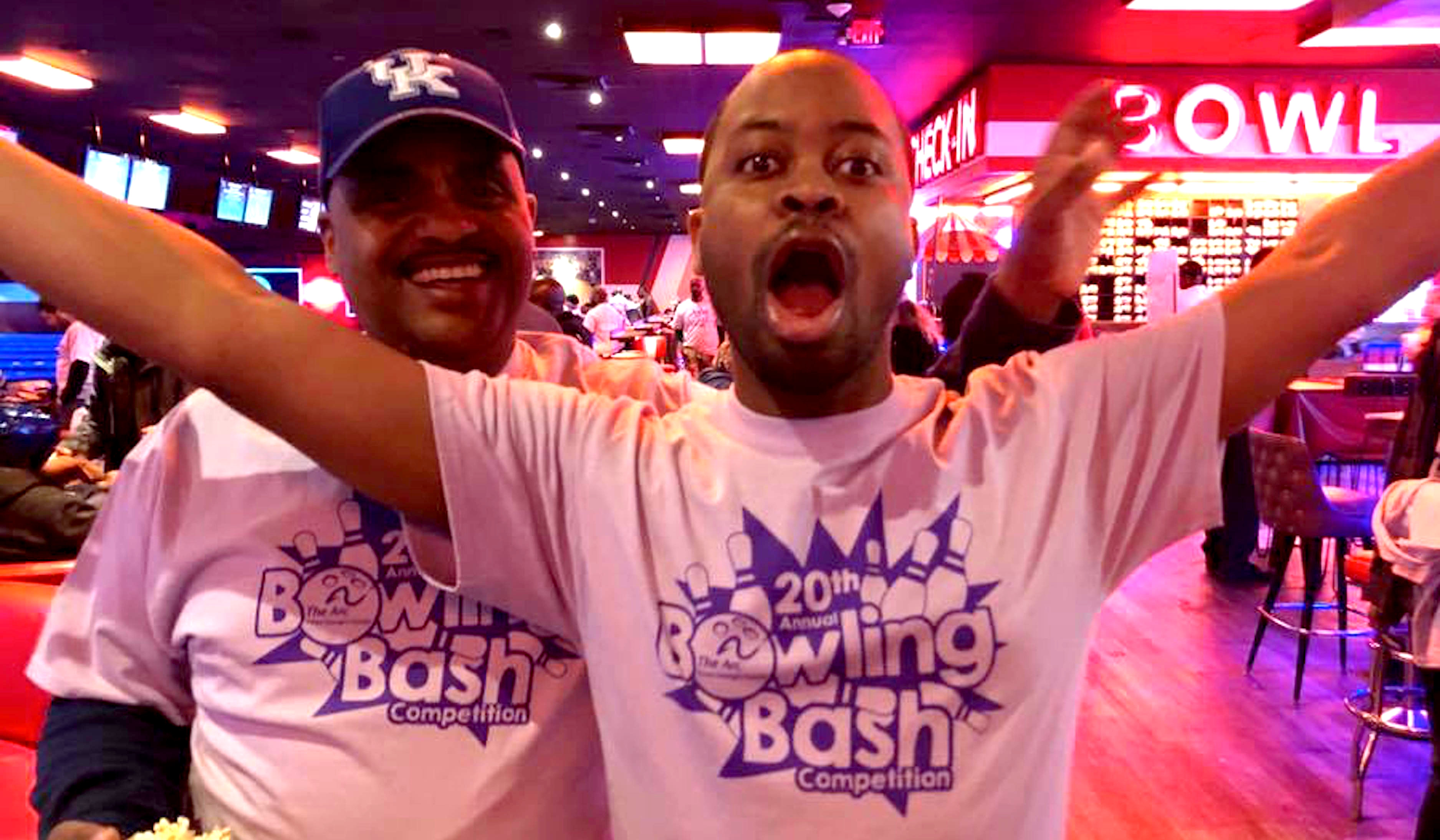 Two men celebrating ARC at a Bowling event