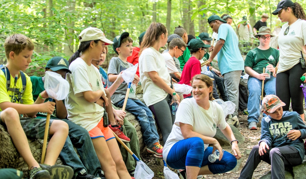 a large diverse group in the woods