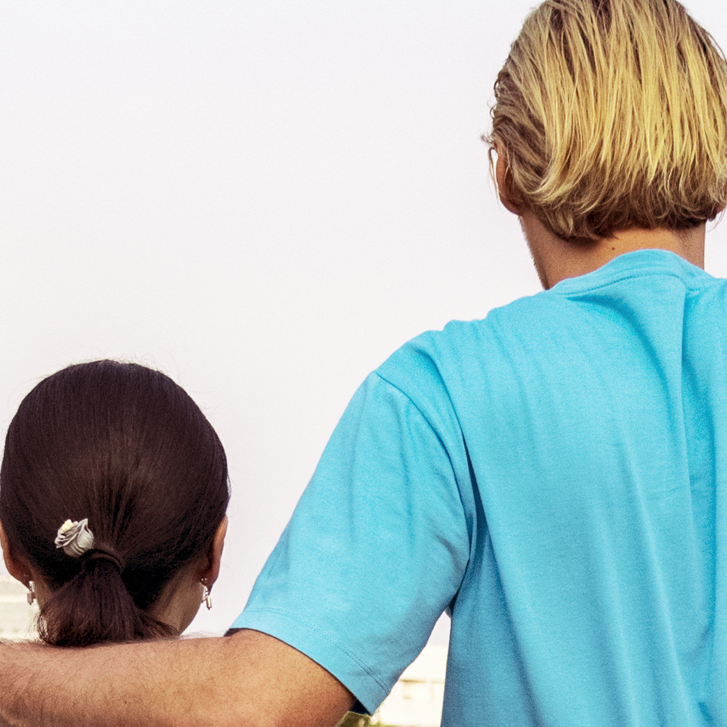 Taller man with arm around shorter woman