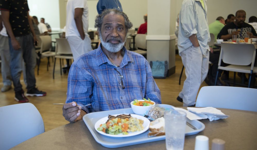 a homeless man eating a meal