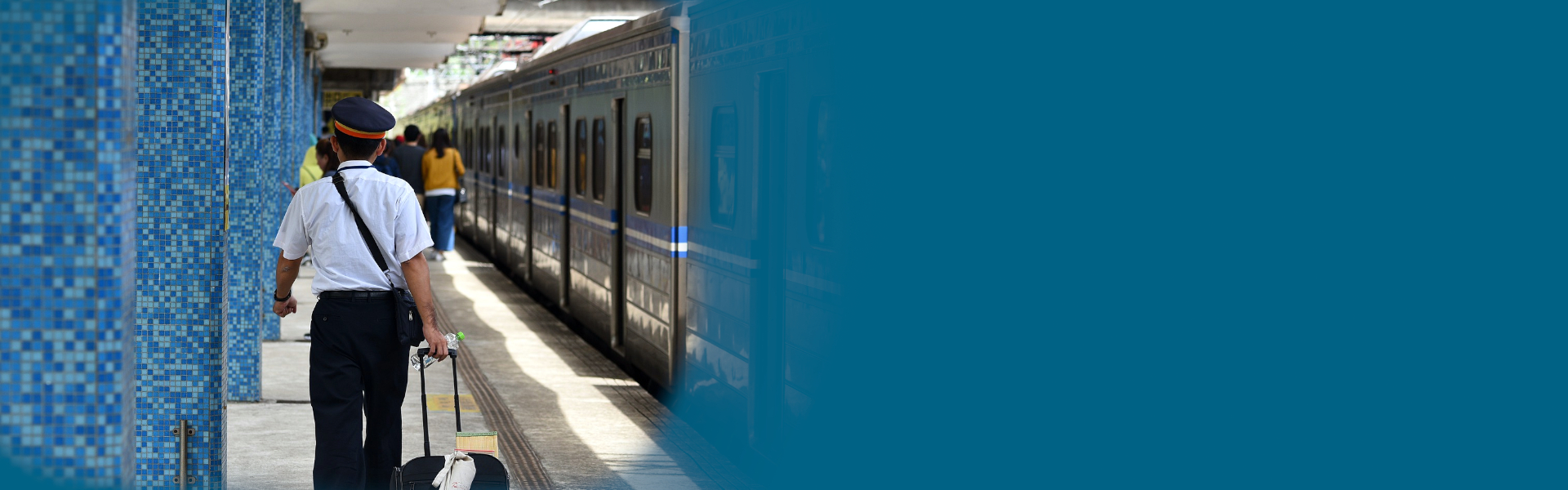 train platform with conductor walking away