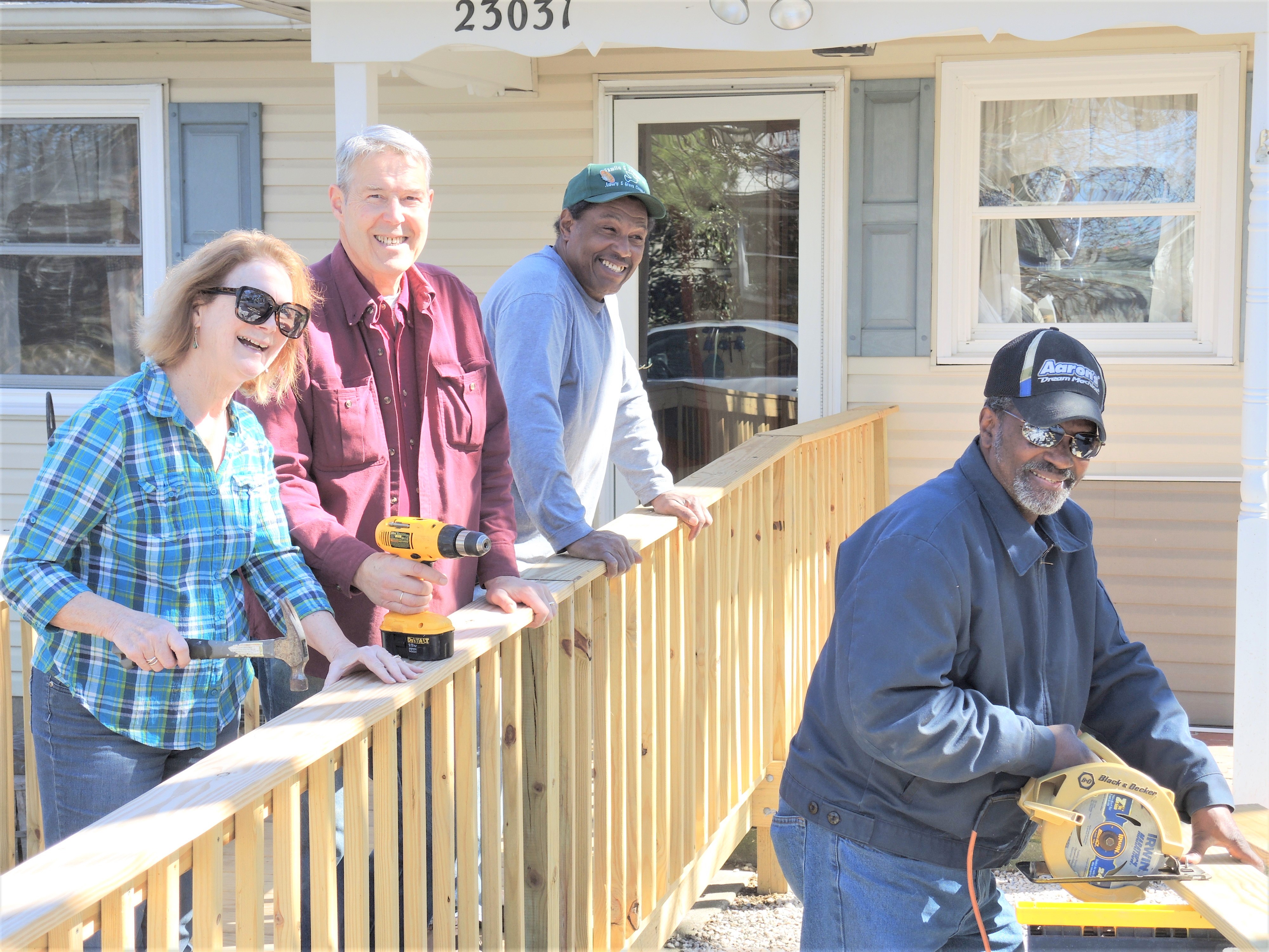 Four people posing for the camera on a new wooden ramp