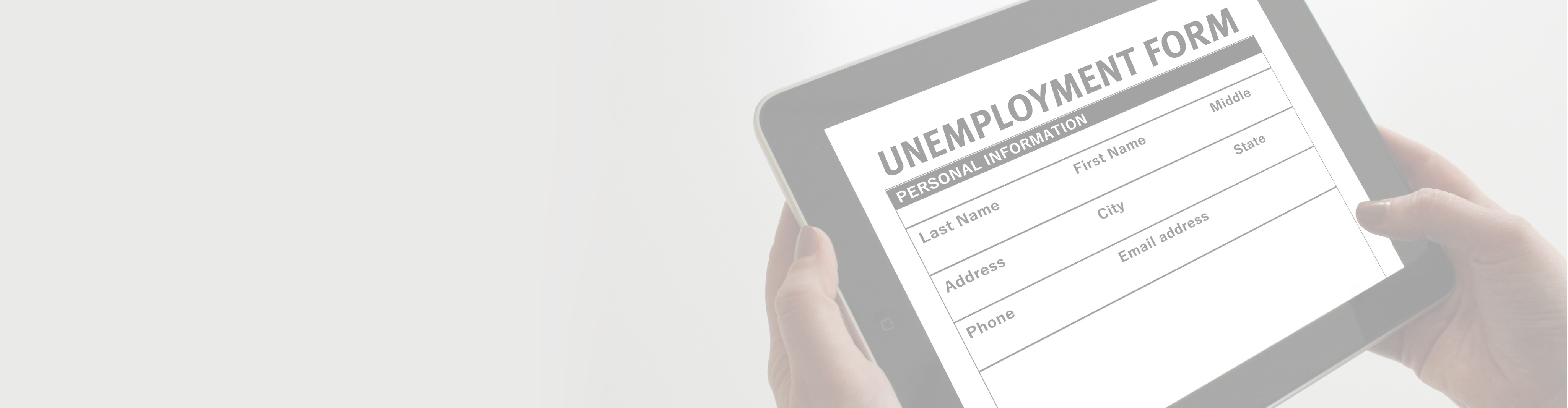 hands holding a tablet with an unemployment form on it