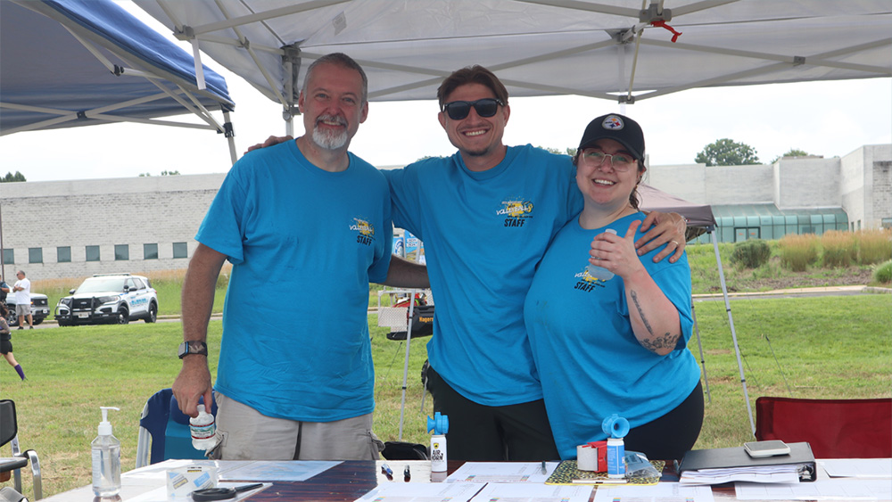 trio smiling in a gazebo