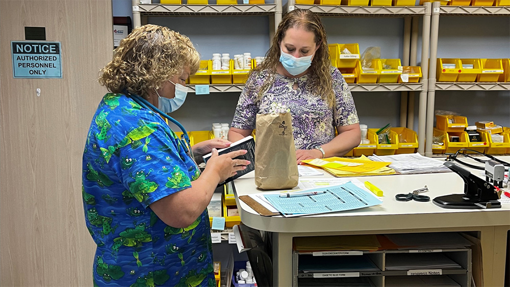 masked workers in pharmacy