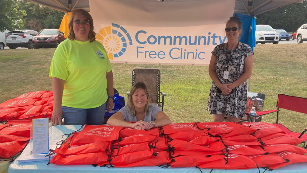 smiling workers at an event table