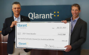 CEO Ron Forsythe and Foundation Chair Dominic Szwaja hold ceremonial check for 2021 Grantees