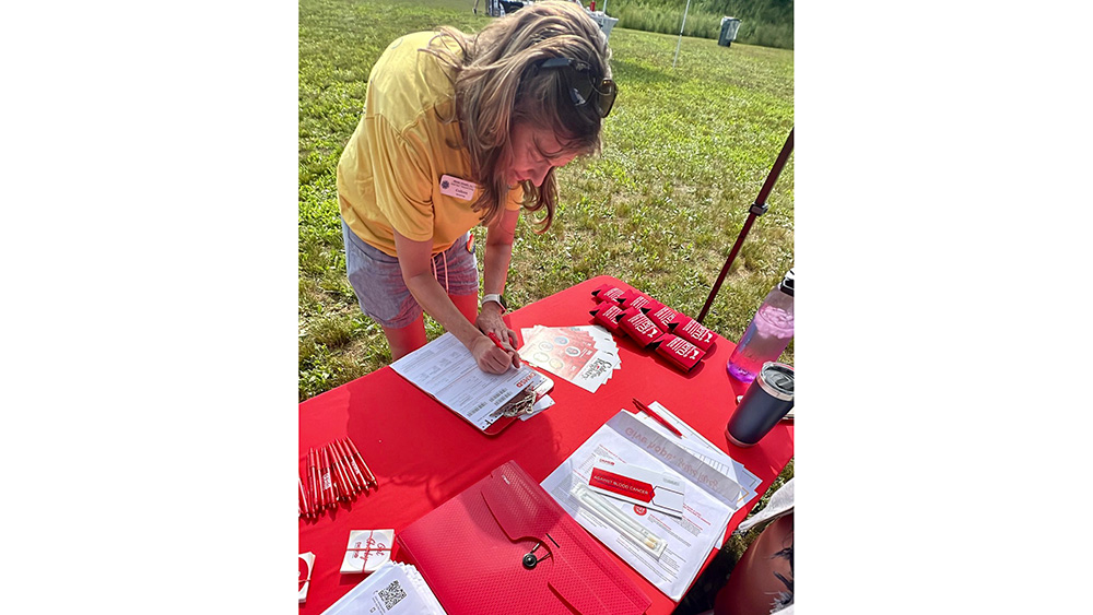 Woman filling out a form at a exhibition booth