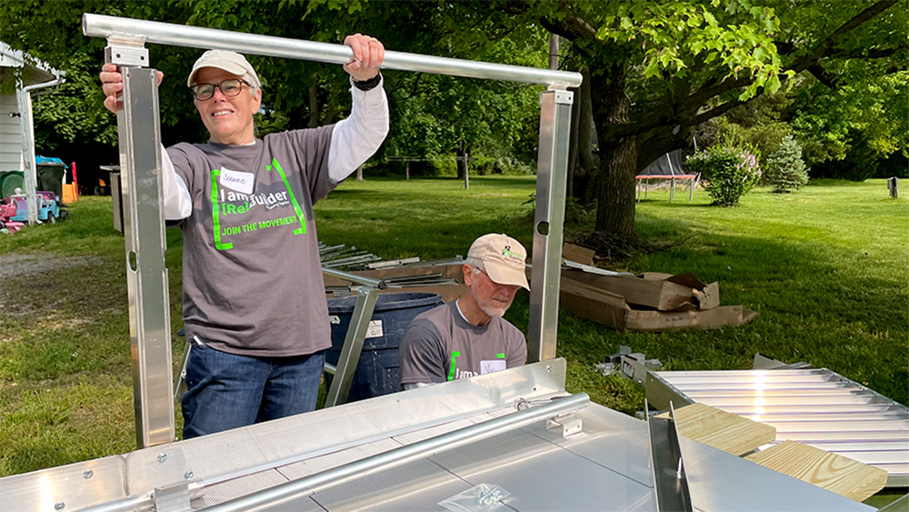 Volunteers work on a metal ramp