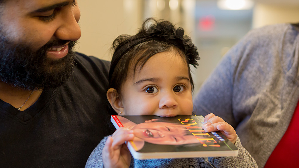 A child biting a book