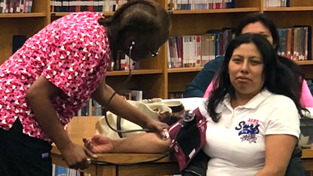 A woman having her blood pressure taken