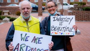 Two people holding handmade signs