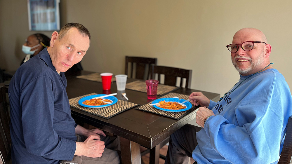 Two men eating lunch at a table
