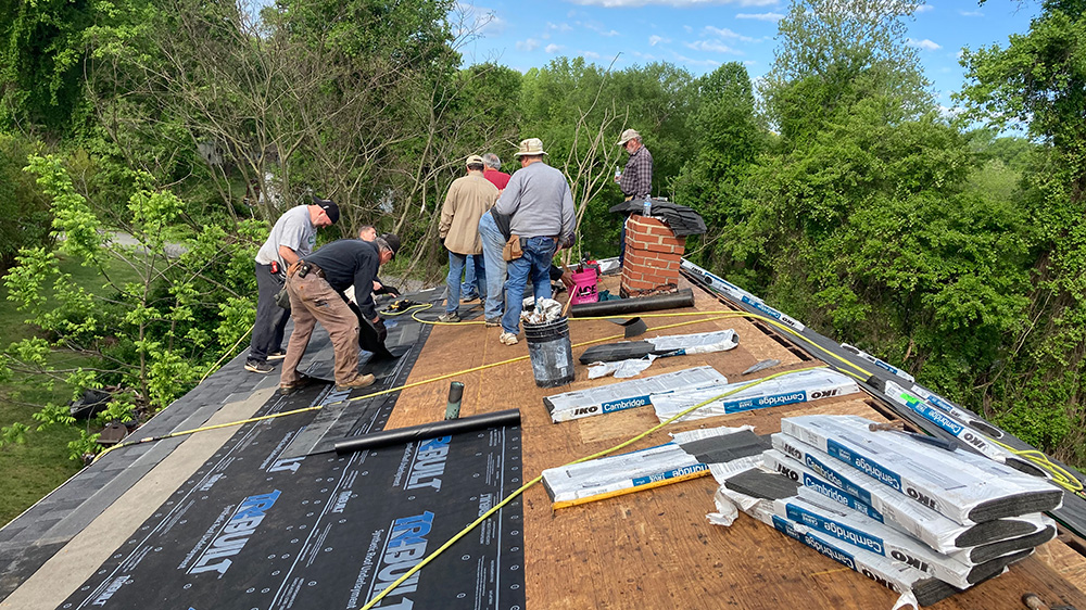 Volunteers working on a roof