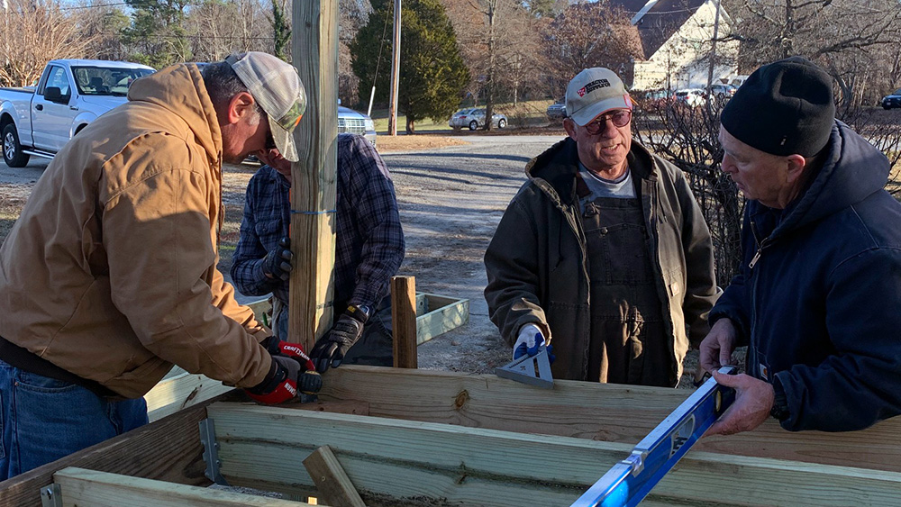 Volunteers working on a wooden deck