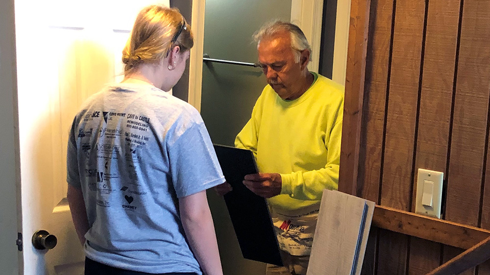 Volunteers looking at new flooring