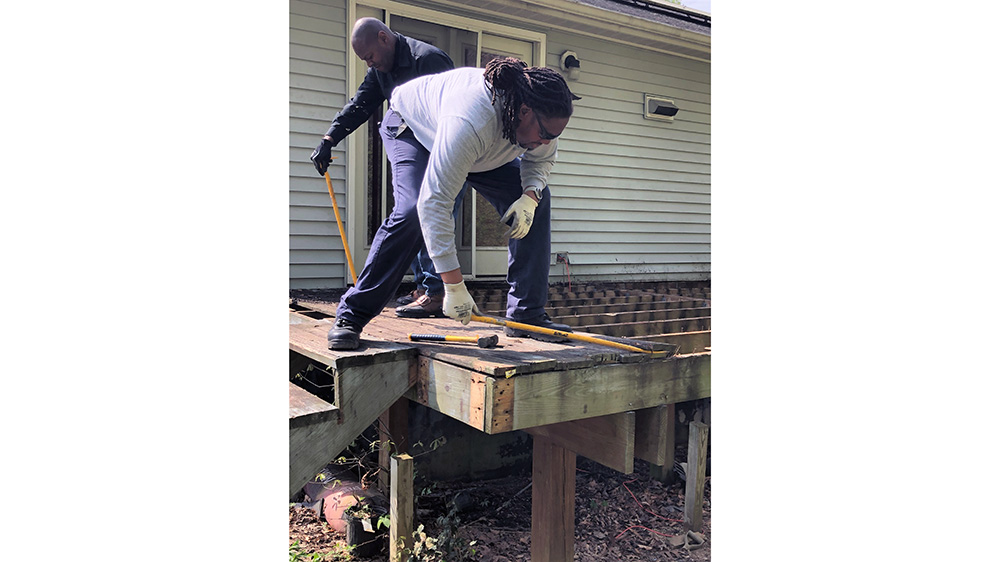 Volunteers working on a wooden deck
