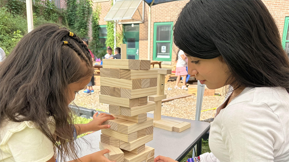 Child Resource Connect Leader with child playing jenga
