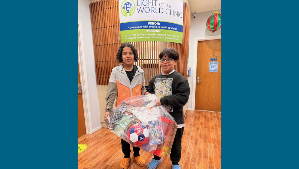 two kids at clinic with gift bags