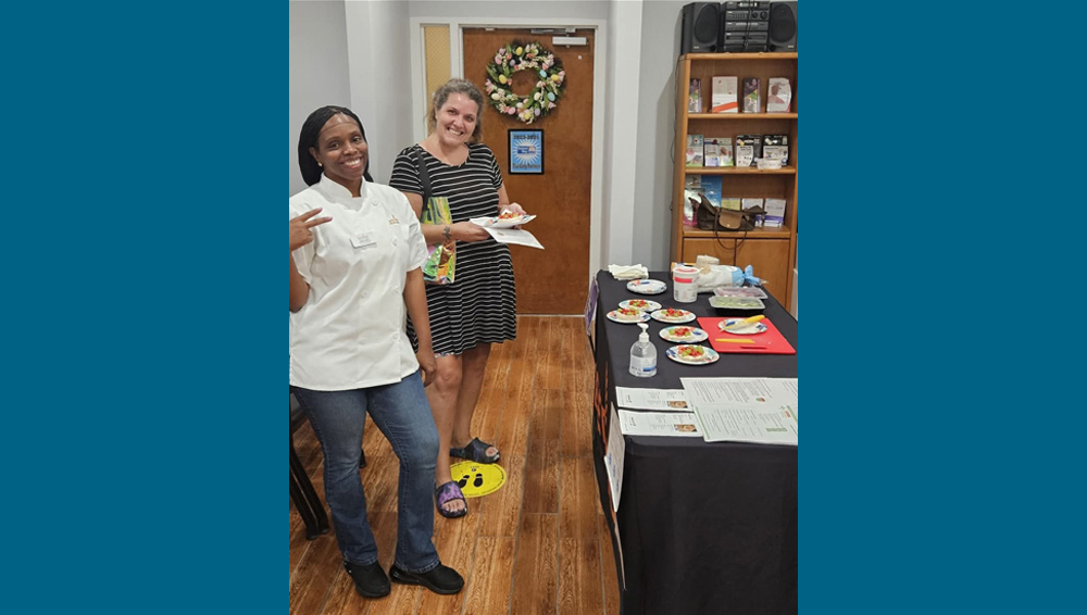 two smiling women at potluck
