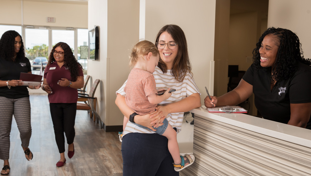 Mother and child at reception desk